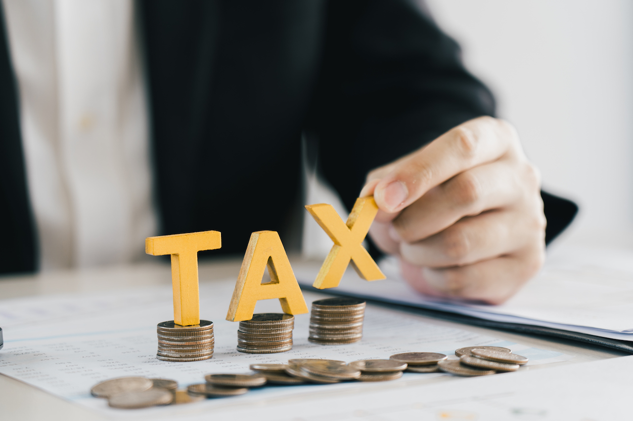 Businessman's hands calculating numbers at a calculator.Tax deduction planning concept.