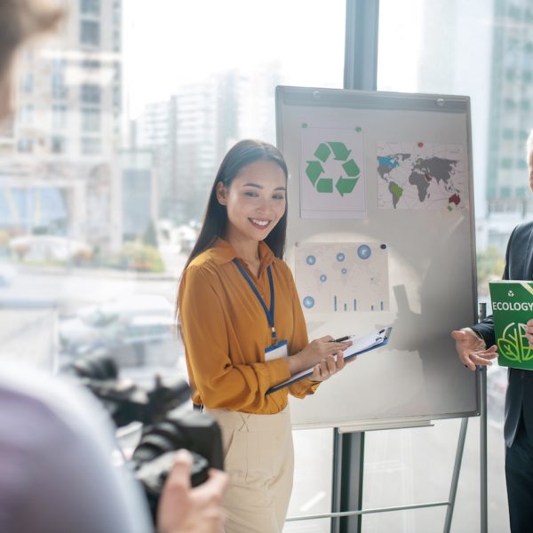 New book. Grey-haired man with a book in his hand looking excited while presenting a new book