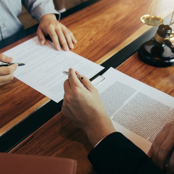 Lawyer is explaining about the wrongdoing laws regarding fraud to the client at the office.