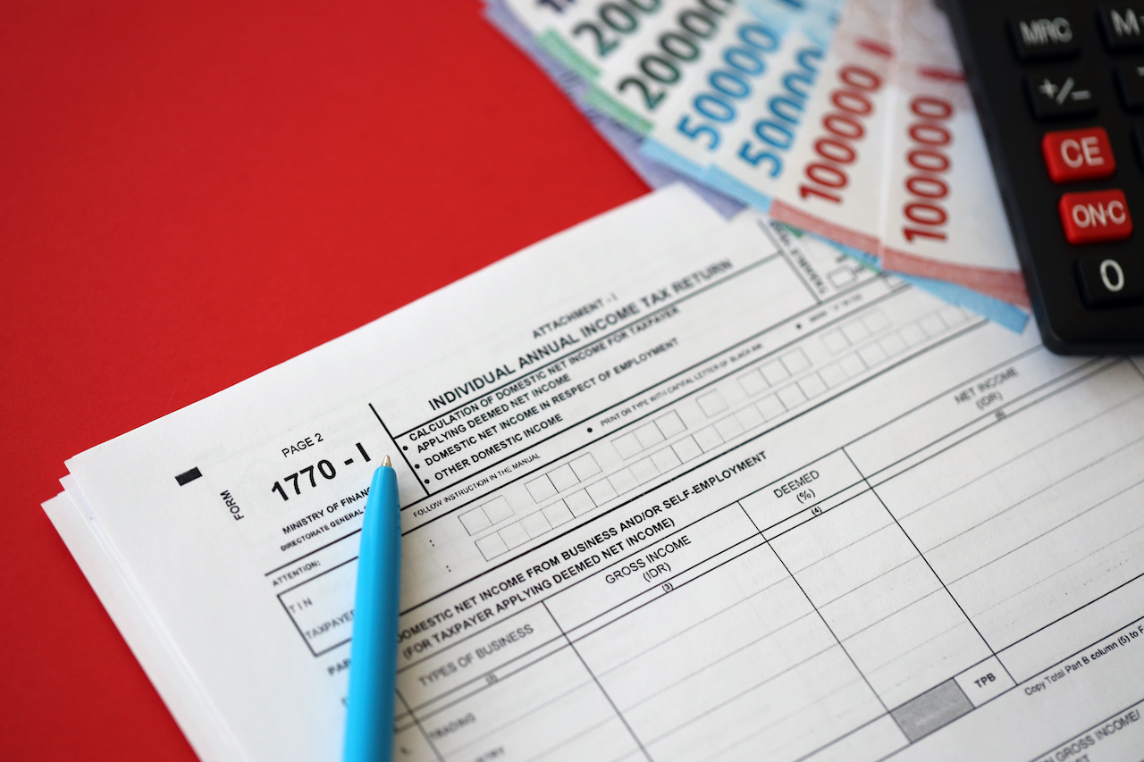 Indonesian tax form 1770-1 Individual Income Tax Return and pen on table close up